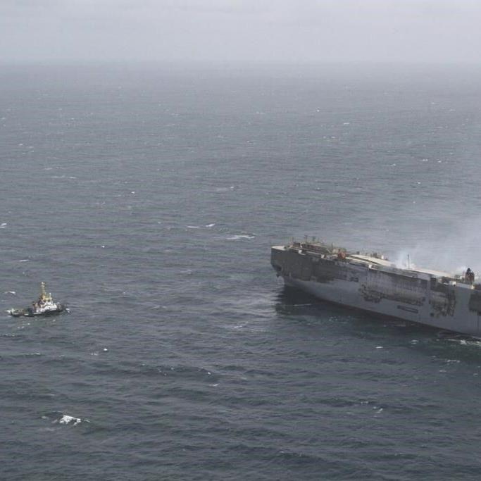 A car-carrying ship that burned for a week on the North Sea is towed to a Dutch port for salvaging